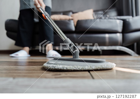 cleaning service housekeeper women swipe floor in living room. House cleaning service concept cleaning service housekeeper women swipe floor in living room. House cleaning service concept 127192287