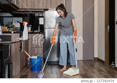 Asian woman cleaning house during weekend, sweeping floor house. cleaning day concept 127192414