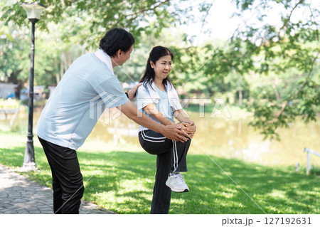 Senior Wellness and Fitness. Elderly couple exercising together in a park, promoting health and vitality. Senior Wellness and Fitness. Elderly couple exercising together in a park, promoting health and vitality. 127192631