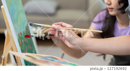 Couple collaborating on a painting. A creative and intimate moment. Couple collaborating on a painting. A creative and intimate moment. 127192692