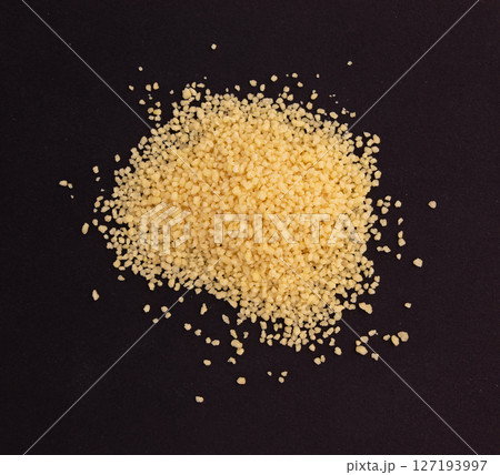 raw couscous isolated on black 127193997