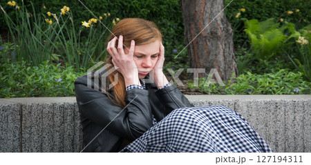 Sad girl in the park 127194311