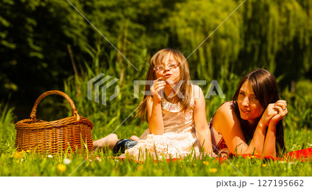 Mother and daughter on picnic. Summer leisure. 127195662