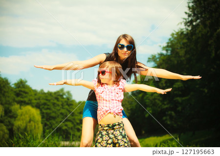 Summer. Girl kid child playing with mother outdoor 127195663