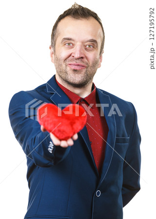 Man in suit holding heart 127195792