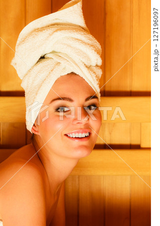 woman lying relaxed in wooden sauna woman lying relaxed in wooden sauna 127196097