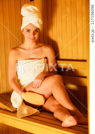 woman relaxing in wooden sauna room woman relaxing in wooden sauna room 127196098