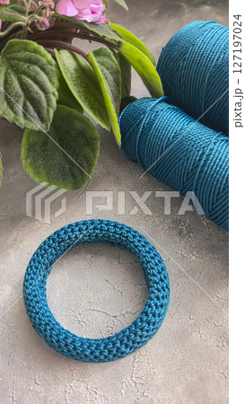 Knitting a cord product with a crochet hook. Step-by-step instructions. 127197024