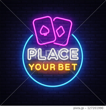 Place Your Bet neon sign with glowing playing cards above, text split in white and orange, casino-style lettering in circle with blue frame. 127201990