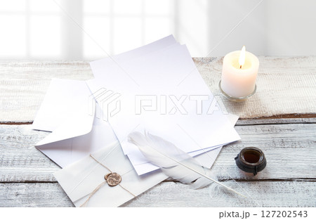 Envelope and paper on white wooden table Envelope and paper on white wooden table 127202543