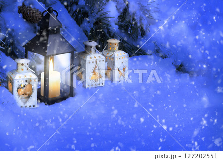 Lanterns in the snow under the Christmas tree Lanterns in the snow under the Christmas tree 127202551