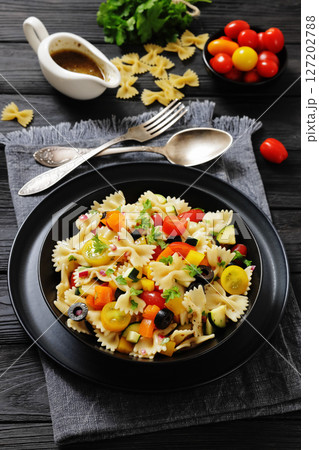 salad of farfalle pasta with veggies and olives salad of farfalle pasta with veggies and olives 127202788