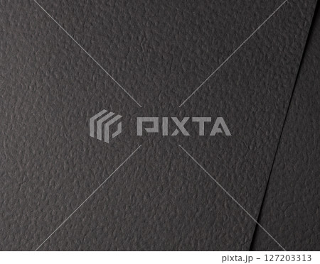 Black matte paper texture with a rough, tactile finish, resembling natural materials like leather Black matte paper texture with a rough, tactile finish, resembling natural materials like leather 127203313