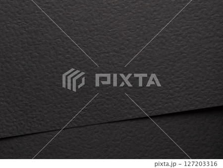 Black matte paper texture with a sleek, modern finish, featuring a minimalistic abstract design. Black matte paper texture with a sleek, modern finish, featuring a minimalistic abstract design. 127203316