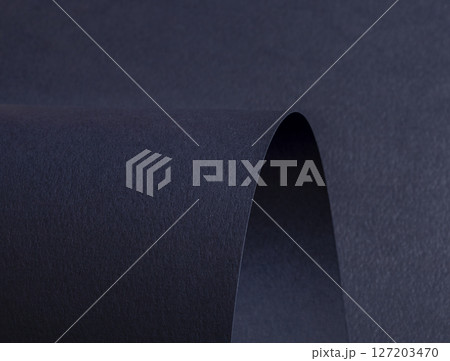 Premium dark blue designer paper with a matte finish. Wavy edges and rolled folds create an abstract Premium dark blue designer paper with a matte finish. Wavy edges and rolled folds create an abstract 127203470