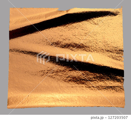 Torn, rippled copper foil texture with a holographic, glossy finish. Frayed, damaged edges creating 127203507