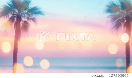 Blurry out-of-focus palm trees by ocean reflecting sunset light, tranquil background 127203965