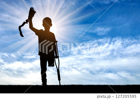 Silhouette of Child with Crutches and Prosthetic Limb 127205595