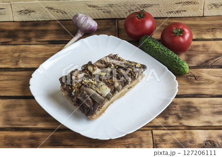 On a white plate is a piece of pork, close - up On a white plate is a piece of pork, close - up 127206111