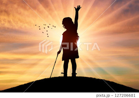 Blind Girl with Cane Raising Hand at Sunset 127206681