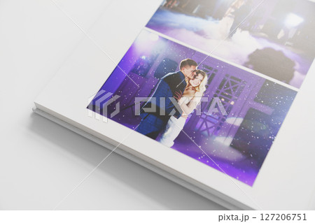 the pages of a photo book with wedding photos.  127206751