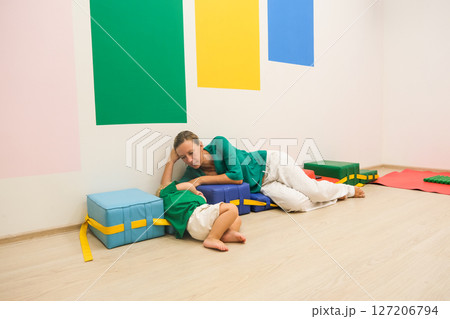 child and mom in kindergarten gym 127206794