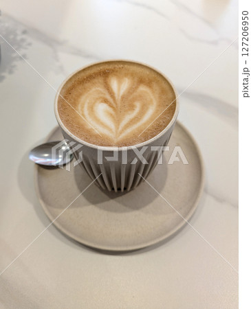 Close Up of an Oat Milk Latte Coffee in White Cup with Love Heart 127206950