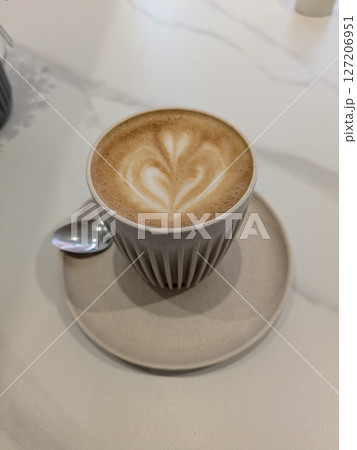 Close Up of an Oat Milk Latte Coffee in White Cup with Love Heart Close Up of an Oat Milk Latte Coffee in White Cup with Love Heart 127206951