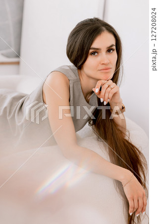 Woman with long hair sitting and chilling with a stylish woven tote bag Woman with long hair sitting and chilling with a stylish woven tote bag 127208024