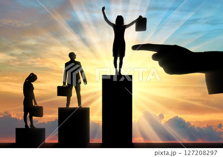 Hiring concept. Silhouette of a finger points to the silhouette of a jubilant woman, next to an upset man and woman Hiring concept. Silhouette of a finger points to the silhouette of a jubilant woman, next to an upset man and woman 127208297