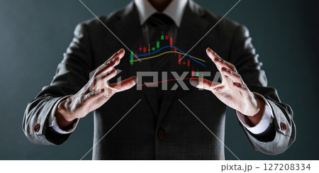 businessman with financial symbols coming from hand, stock markets concept. 127208334