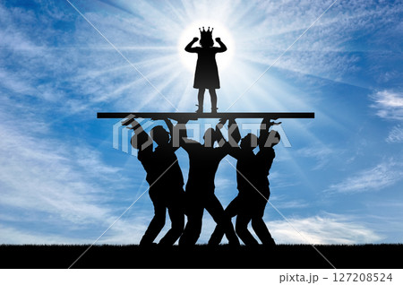 Childish selfishness. A crowd of people is holding a selfish child girl with a crown on her head on a pedestal Childish selfishness. A crowd of people is holding a selfish child girl with a crown on her head on a pedestal 127208524