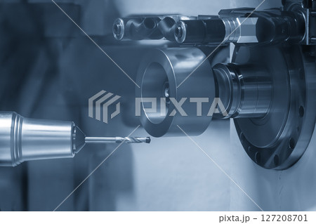 The drill tool regrinding machine control by CNC program in the light blue scene. 127208701