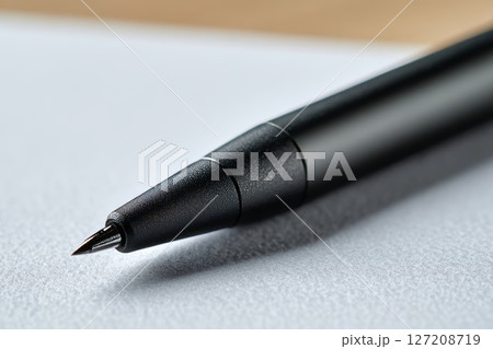 Closeup of a Black Stylus on Paper. Closeup of a Black Stylus on Paper. 127208719