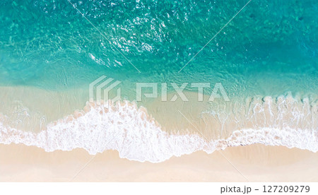 waves on the beach, view of a sandy beach with a gentle ocean wave washing ashore. The soft foam contrasts with the fine sand, peaceful coastal scene, smooth sand in the foreground, gentle ocean wave waves on the beach, view of a sandy beach with a gentle ocean wave washing ashore. The soft foam contrasts with the fine sand, peaceful coastal scene, smooth sand in the foreground, gentle ocean wave 127209279