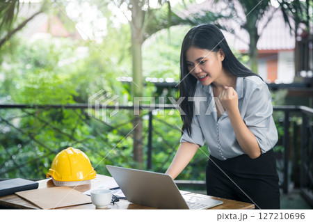 Asian female architects clenched her fist and shouted YEAH!! Glad to know that the client likes her work and agrees to sign a contract. Successful project. Asian female architects clenched her fist and shouted YEAH!! Glad to know that the client likes her work and agrees to sign a contract. Successful project. 127210696