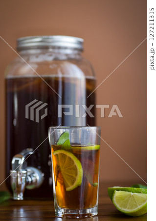 Refreshing kombucha in a glass jar and a glass with lime Refreshing kombucha in a glass jar and a glass with lime 127211315