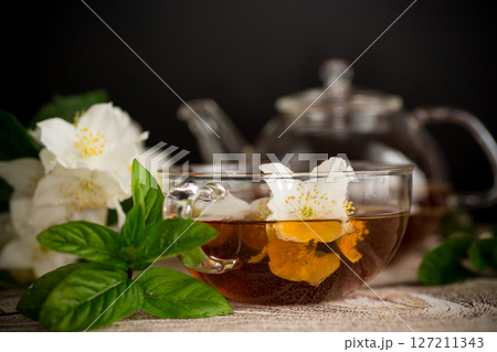 Cup with jasmine tea on a black background Cup with jasmine tea on a black background 127211343