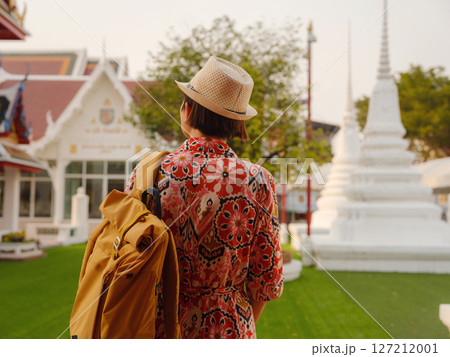 Woman Exploring Colorful Streets Near Buddhist Temples in Bangkok. Female traveler strolling through charming streets of Bangkok, surrounded by traditional architecture and beautiful Buddhist temples. Woman Exploring Colorful Streets Near Buddhist Temples in Bangkok. Female traveler strolling through charming streets of Bangkok, surrounded by traditional architecture and beautiful Buddhist temples. 127212001