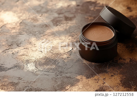 Open jar of cream in glass bottle on bronze podium. Cosmetic packaging mockup. 127212558