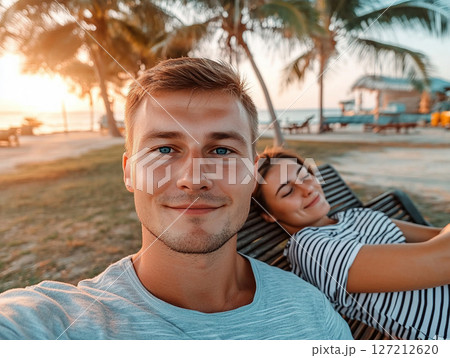 A young couple takes a selfie while on holiday in a tropical country. Generated by artificial intelligence 127212620