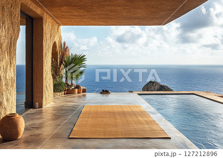 Picturesque oceanfront villa overlooking an infinity pool and laid out yoga mat 127212896