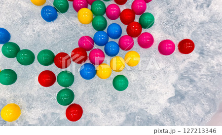 Colorful plastic balls floating on bubbling water surface Colorful plastic balls floating on bubbling water surface 127213346
