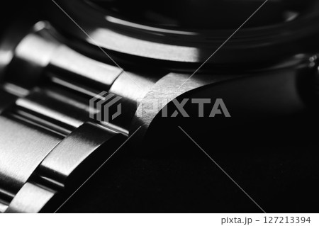 Detailed black-and-white macro shot of a metallic watch bracelet Detailed black-and-white macro shot of a metallic watch bracelet 127213394