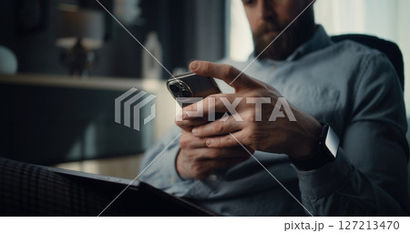 Close Up of Successful Businessman Working on Smartphone, Monitoring Exchange Market Charts 127213470
