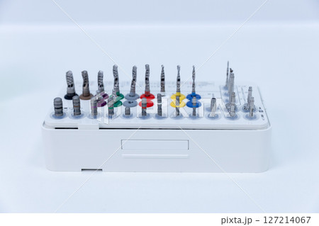 Comprehensive Set of Precision Tools Organized Neatly on a White Tray Showcasing Various Drill Bits and Accessories Ready for Professional Use in Engineering or Craft Applications 127214067