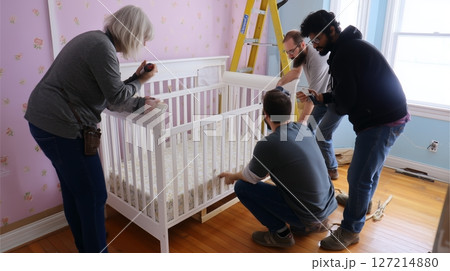 Family gathers to assemble a crib in a cozy nursery during a sunny afternoon at home 127214880