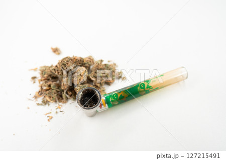 Bong and Ground Cannabis Sitting on a White 127215491