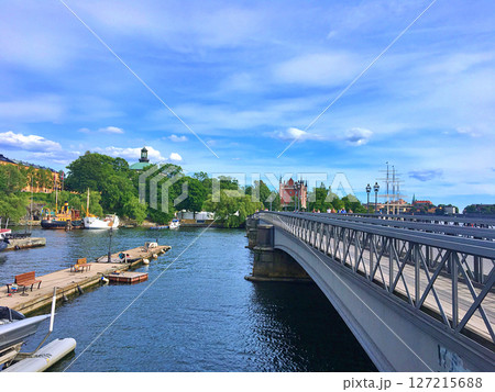 Skeppsholmsbron bridge with famous golden crown and view on Museum and sailing vessel in Stockholm, Sweden Skeppsholmsbron bridge with famous golden crown and view on Museum and sailing vessel in Stockholm, Sweden 127215688