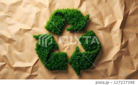 A green recycling symbol displayed on crumpled paper, underscoring themes of sustainability and environmental awareness for Earth Day A green recycling symbol displayed on crumpled paper, underscoring themes of sustainability and environmental awareness for Earth Day 127217398